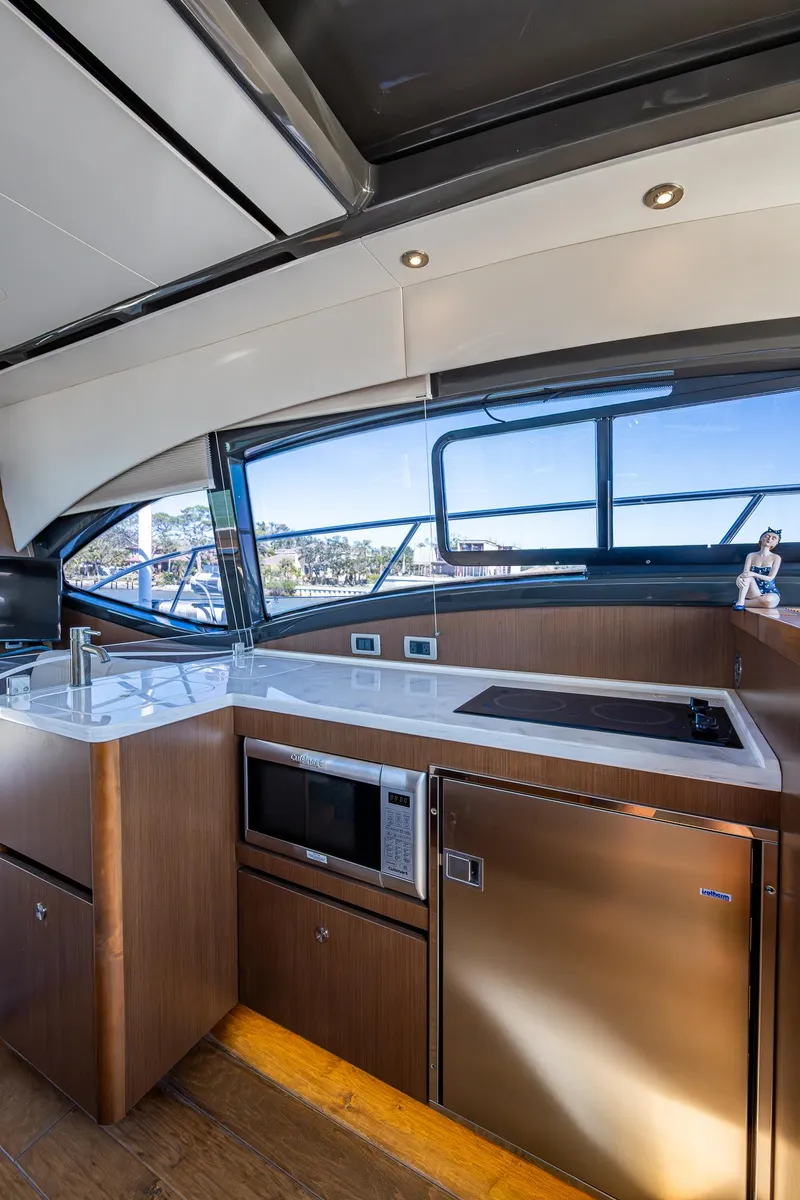 Slide: The Image of Interior of 2017 Sea Ray Sundancer 400 yacht with modern kitchen amenities. - 35