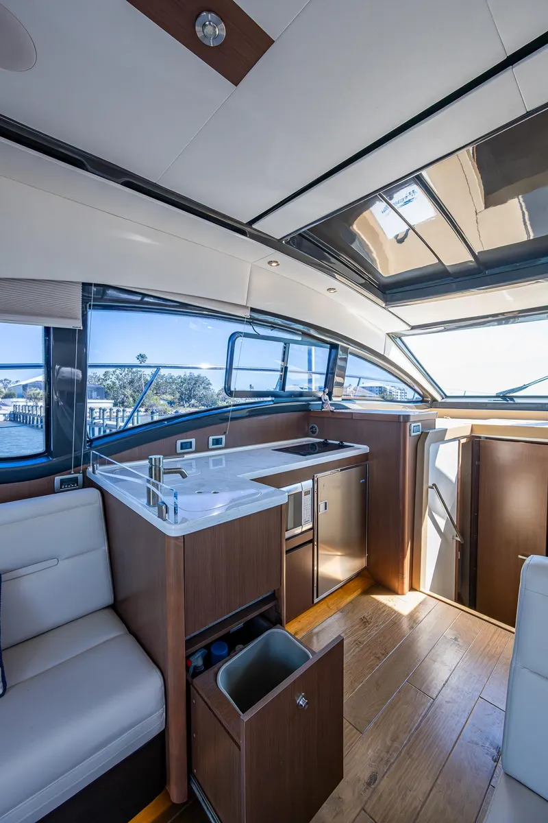 Slide: The Image of Interior of 2017 Sea Ray Sundancer 400 yacht with modern kitchen and seating area. - 36