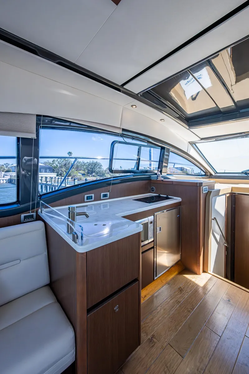 Slide: The Image of Interior of 2017 Sea Ray Sundancer 400 yacht, featuring modern kitchen and seating area. - 37