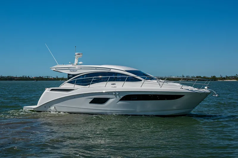 Slide: The Image of 2017 Sea Ray Sundancer 400 yacht cruising on open water under clear blue sky. - 5