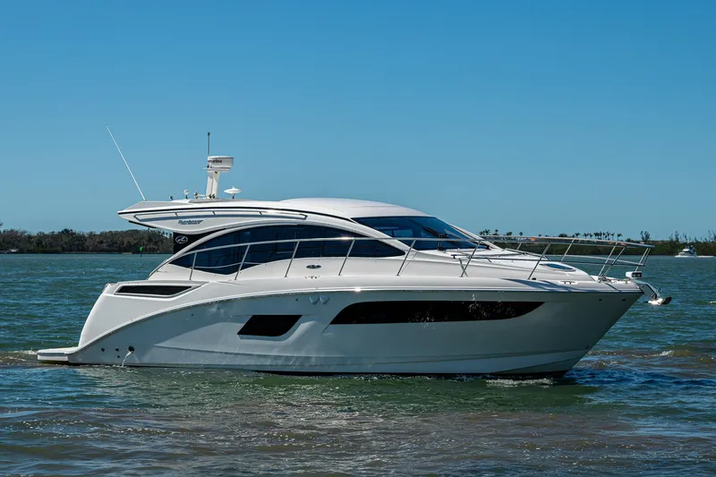 Slide: The Image of 2017 Sea Ray Sundancer 400 yacht cruising on calm waters under clear blue sky. - 6