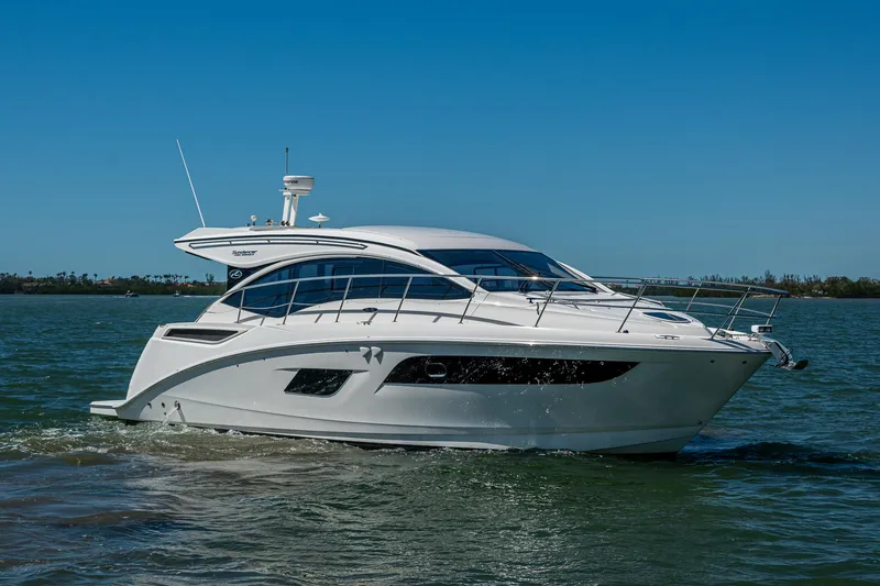 Slide: The Image of 2017 Sea Ray Sundancer 400 yacht cruising on open water under clear blue skies. - 7