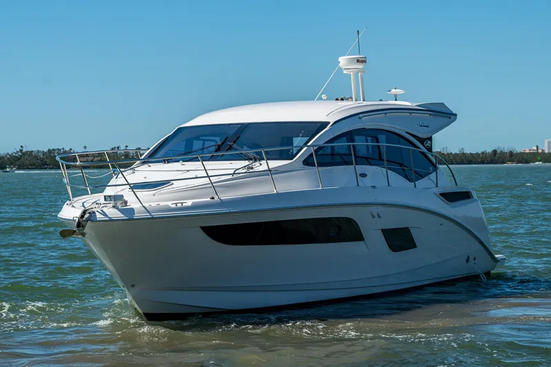 Slide: The Image of 2017 Sea Ray Sundancer 400 yacht cruising on open water under clear blue skies. - 8
