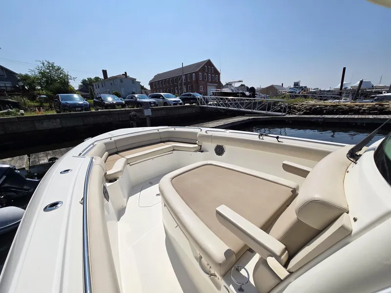 Slide: The Image of 2017 Boston Whaler 330 Outrage boat with spacious seating at a dock. - 10