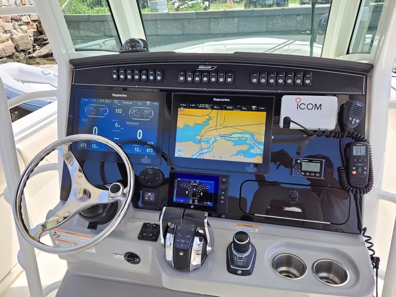 Slide: The Image of Control panel of 2017 Boston Whaler 330 Outrage with navigation screens and steering wheel. - 11
