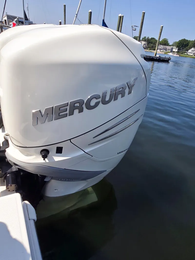 Slide: The Image of Mercury outboard engine on a 2017 Boston Whaler 330 Outrage, docked in a marina. - 15