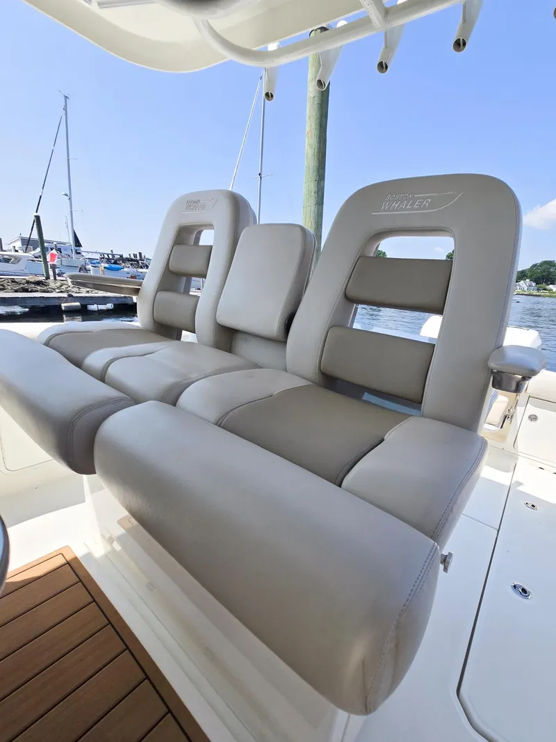 Slide: The Image of 2017 Boston Whaler 330 Outrage boat seats, docked with marina view. - 18
