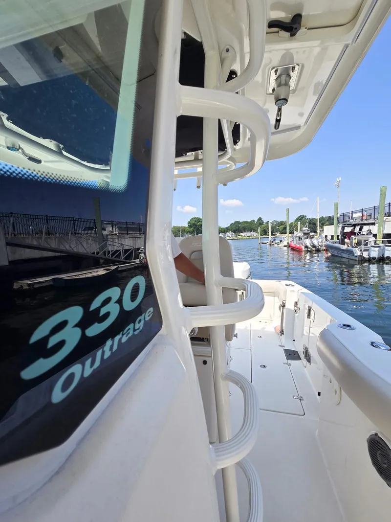 Slide: The Image of 2017 Boston Whaler 330 Outrage boat docked at marina, sunny day. - 4