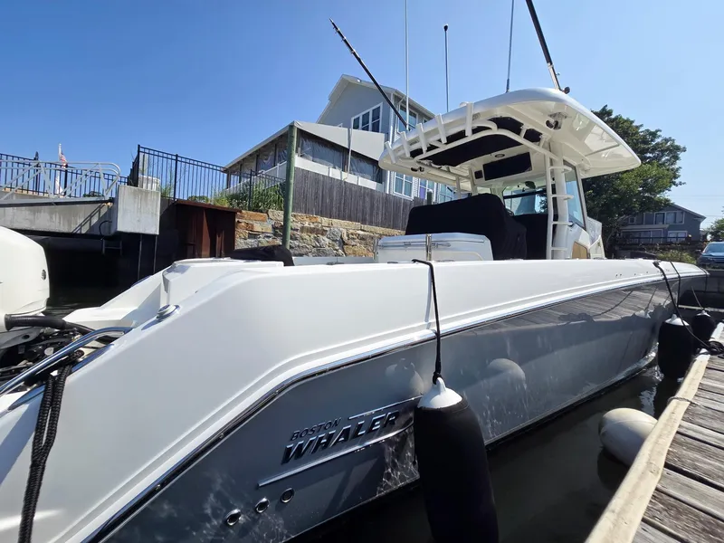 Slide: The Image of 2017 Boston Whaler 330 Outrage docked, showcasing sleek design and modern features. - 5