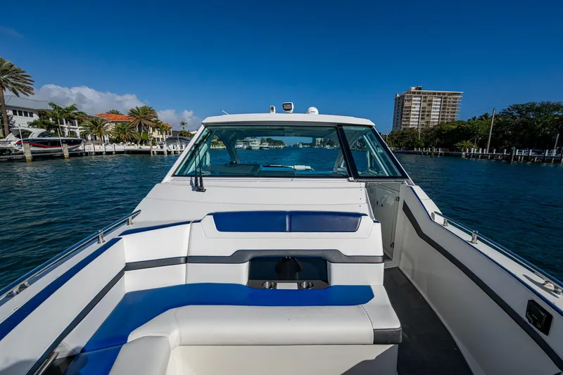 Slide: The Image of 2021 Formula 380 Super Sport Crossover OB on water, showcasing sleek design and spacious seating. - 12