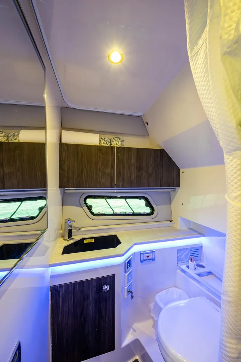 Slide: The Image of 2021 Formula 380 Super Sport Crossover OB bathroom with modern fixtures and ambient lighting. - 17