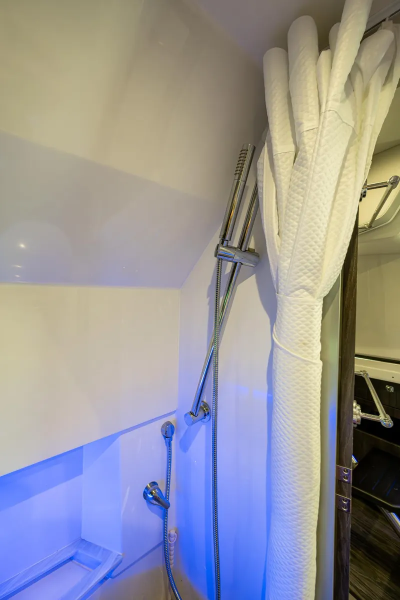 Slide: The Image of 2021 Formula 380 Super Sport Crossover OB bathroom with shower and curtain. - 19