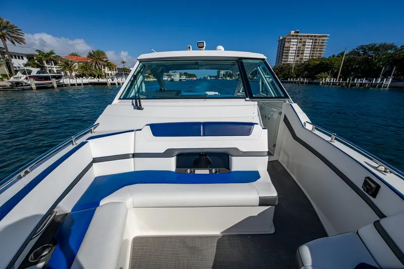 Slide: The Image of 2021 Formula 380 Super Sport Crossover OB boat interior with blue and white seating. - 20