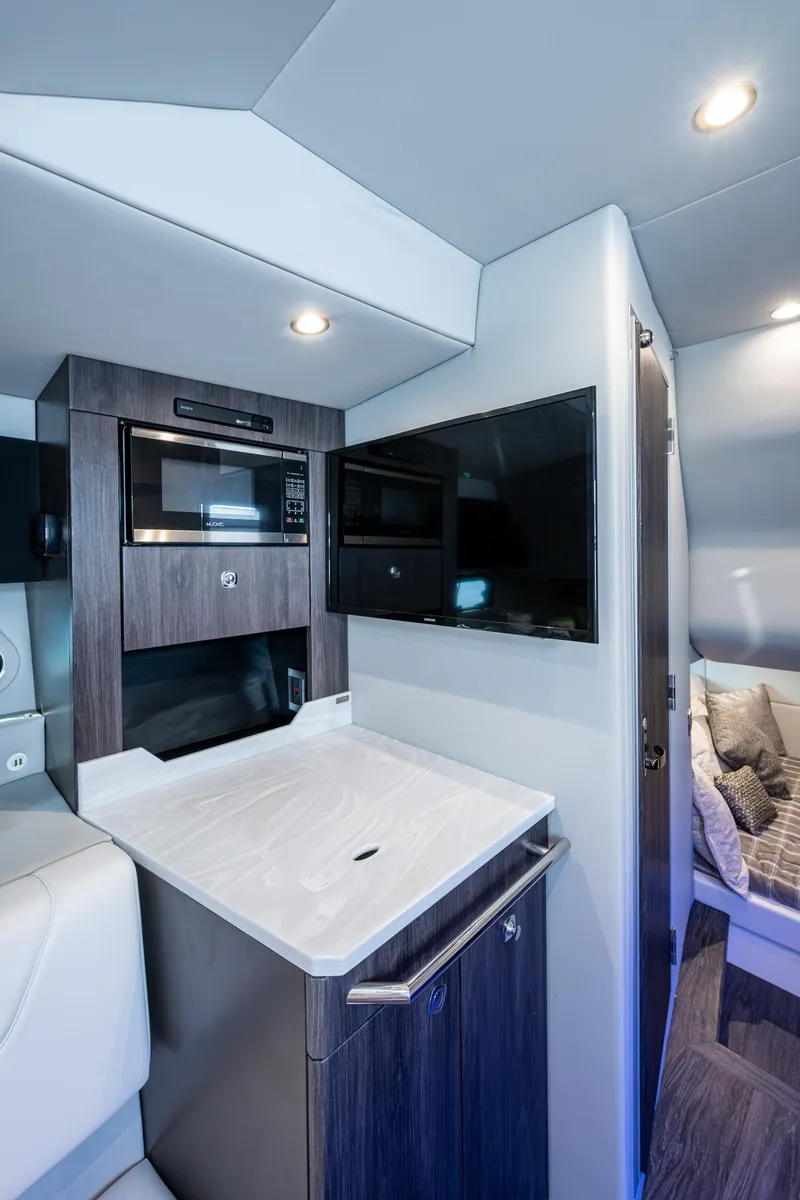 Slide: The Image of 2021 Formula 380 Super Sport Crossover OB interior with kitchenette and TV. - 21