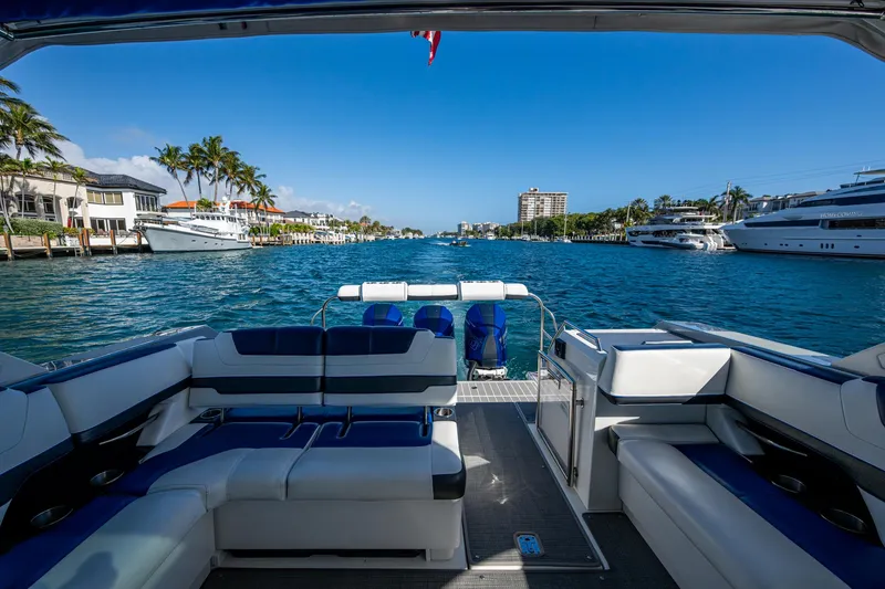 Slide: The Image of 2021 Formula 380 Super Sport Crossover OB on scenic waterfront with luxury yachts. - 22