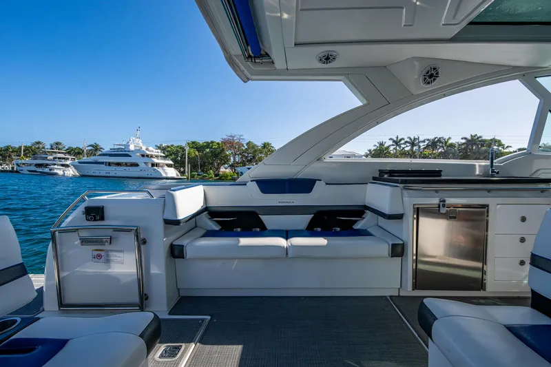 Slide: The Image of Interior of 2021 Formula 380 Super Sport Crossover OB boat, featuring luxurious seating and waterfront view. - 24