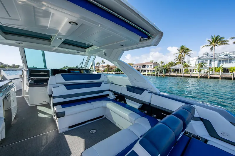 Slide: The Image of 2021 Formula 380 Super Sport Crossover OB boat interior with luxurious seating and waterfront view. - 32