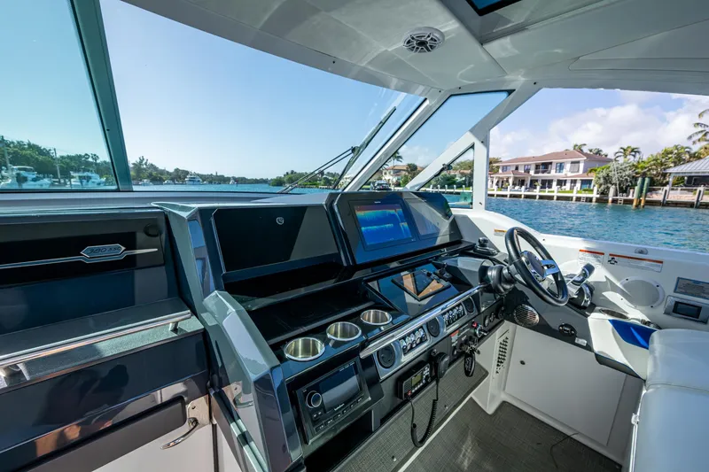 Slide: The Image of 2021 Formula 380 Super Sport Crossover OB helm with modern controls and waterfront view. - 34