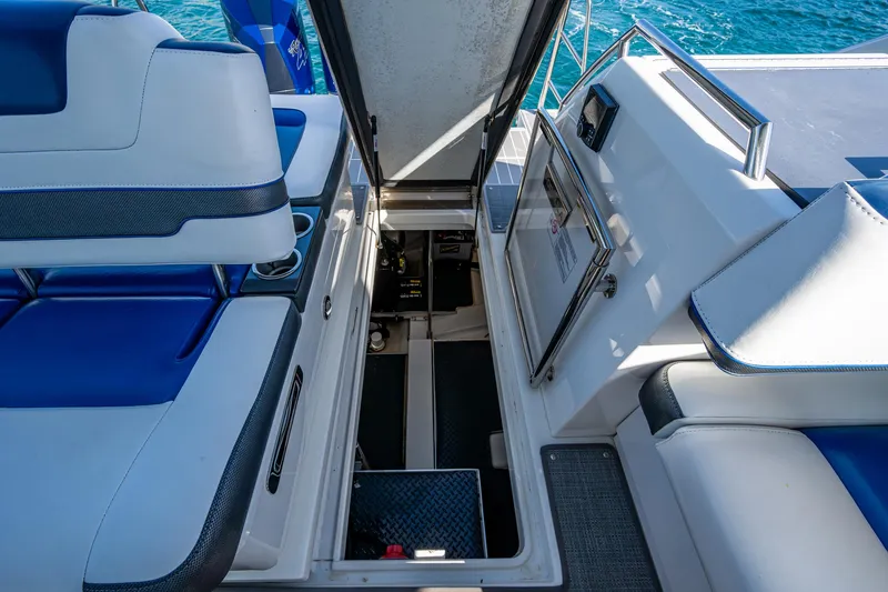 Slide: The Image of 2021 Formula 380 Super Sport Crossover OB interior with open storage compartment, blue and white seating. - 37
