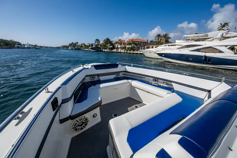 Slide: The Image of 2021 Formula 380 Super Sport Crossover OB on scenic waterfront, featuring luxurious seating and sleek design. - 6