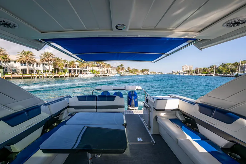 Slide: The Image of 2021 Formula 380 Super Sport Crossover OB cruising on a scenic waterway with luxurious seating. - 7