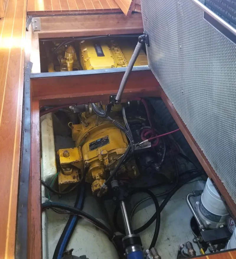 Slide: The Image of Engine compartment of 1990 Pettegrow 36 Flybridge boat, showcasing yellow machinery and components. - 10
