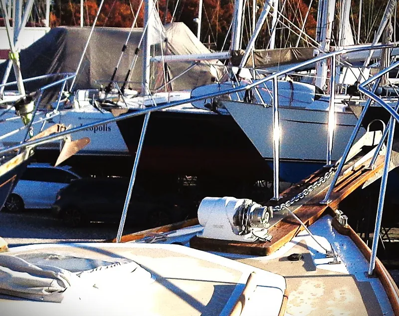Slide: The Image of Pettegrow 36 Flybridge 1990 yacht docked among other boats, showcasing its deck and anchor chain. - 15