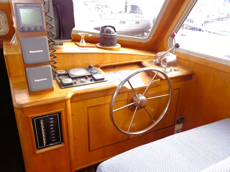 Slide: The Image of Interior helm of 1990 Pettegrow 36 Flybridge with wooden dashboard and navigation equipment. - 2