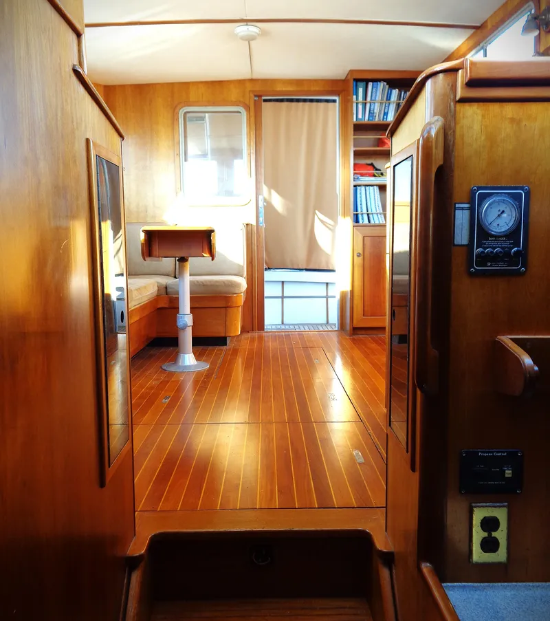 Slide: The Image of Interior of 1990 Pettegrow 36 Flybridge yacht with wooden flooring and seating area. - 4