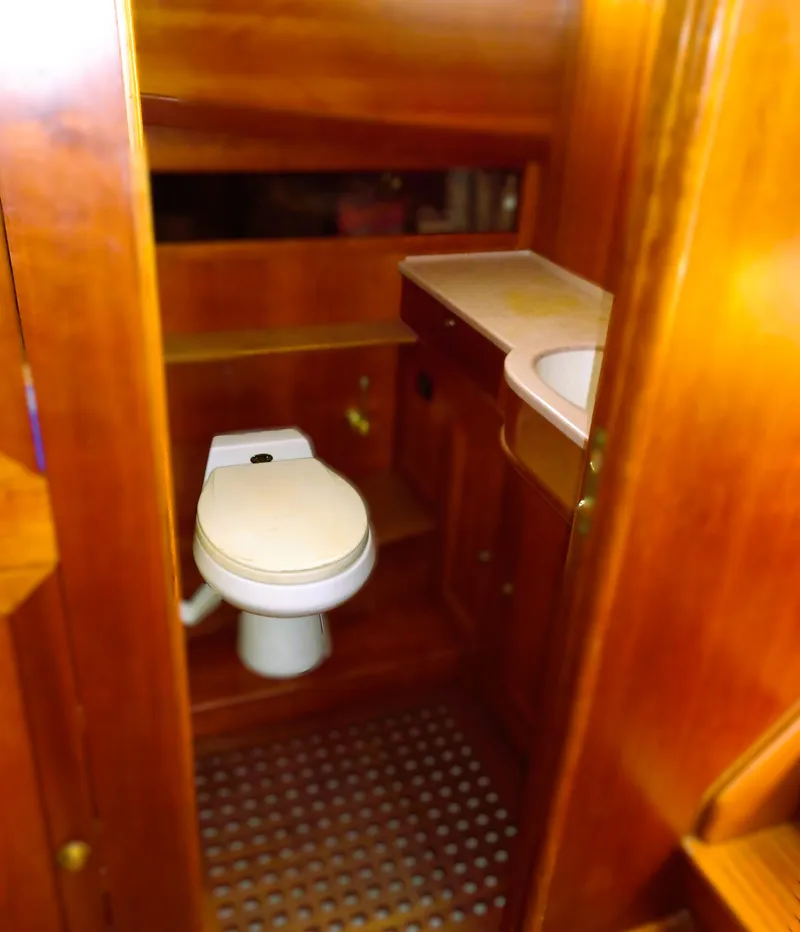 Slide: The Image of 1990 Pettegrow 36 Flybridge yacht bathroom with wooden interior and compact design. - 9