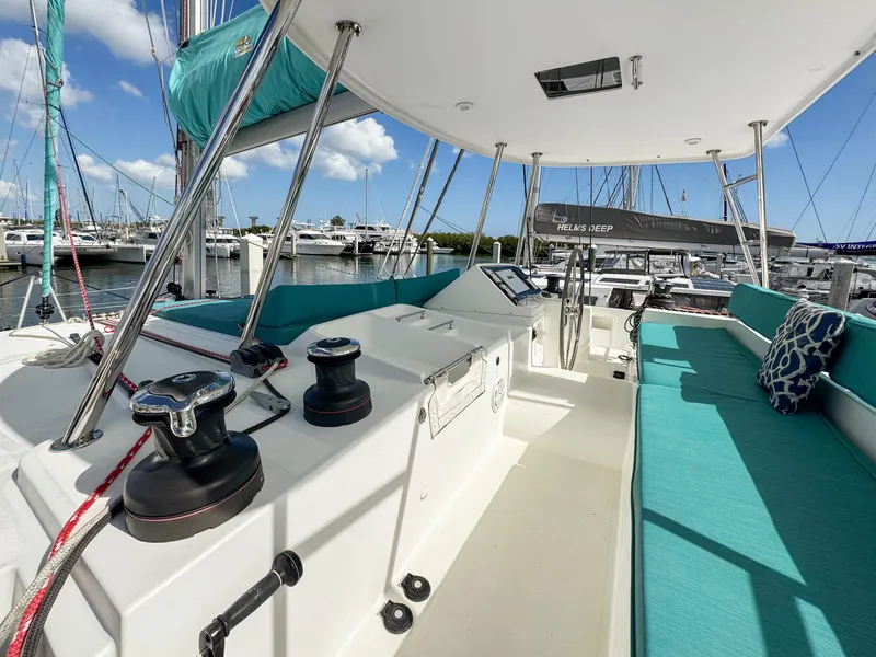Slide: The Image of 2017 Lagoon 450 F catamaran interior with turquoise seating, docked at marina. - 18