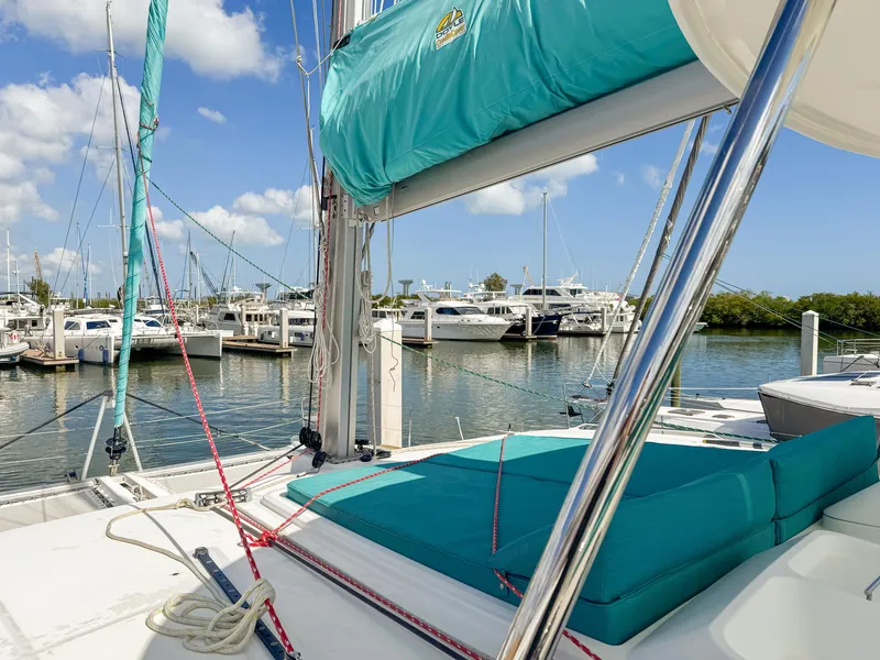 Slide: The Image of 2017 Lagoon 450 F catamaran docked at marina with turquoise cushions and clear sky. - 20