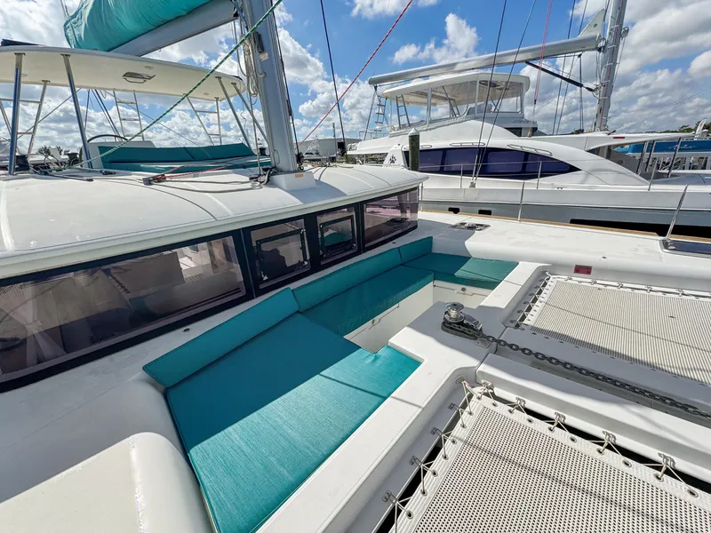 Slide: The Image of 2017 Lagoon 450 F catamaran with turquoise seating and spacious deck under a blue sky. - 22