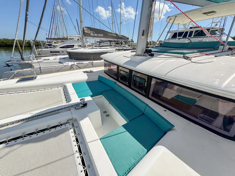 Slide: The Image of 2017 Lagoon 450 F catamaran with turquoise seating, docked in a marina. - 23