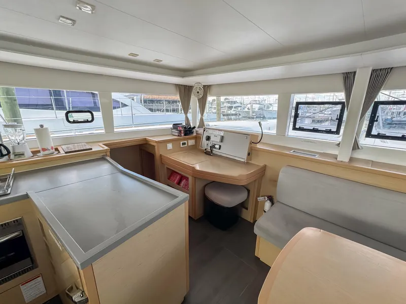 Slide: The Image of Interior of 2017 Lagoon 450 F catamaran, featuring modern navigation equipment and spacious seating area. - 28