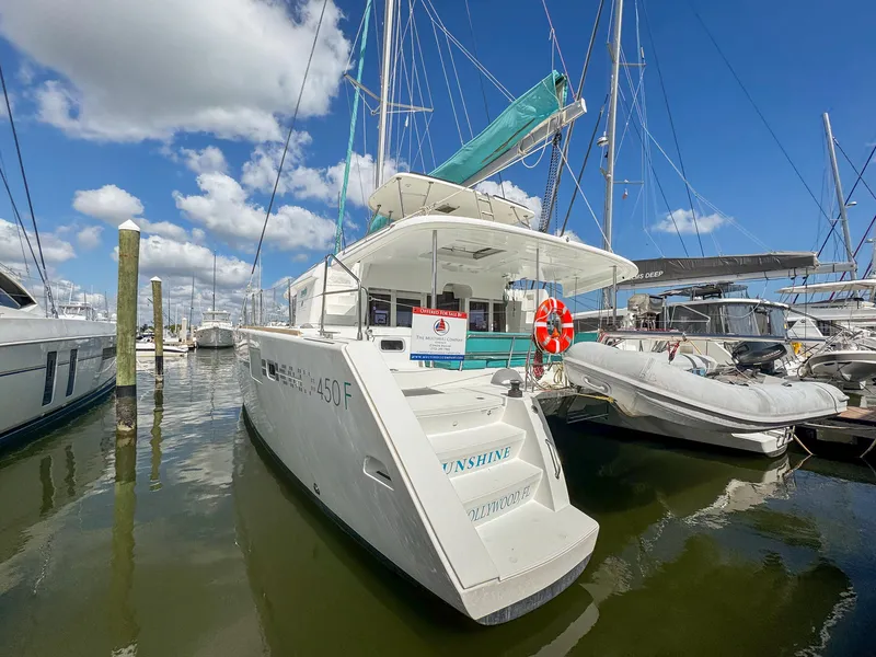 Slide: The Image of 2017 Lagoon 450 F catamaran docked at marina under blue sky. - 3