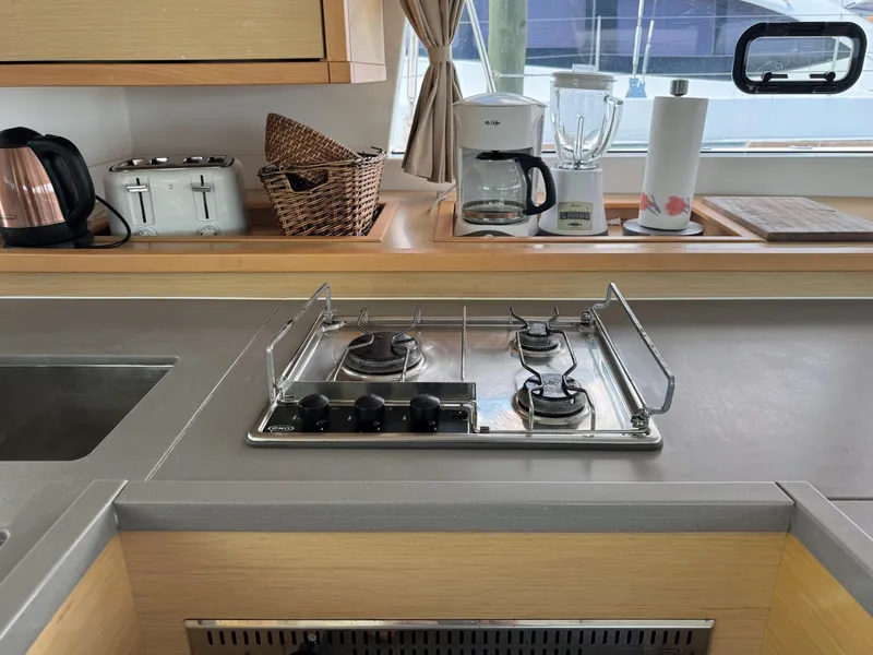 Slide: The Image of Modern kitchen in 2017 Lagoon 450 F yacht with stove, appliances, and window view. - 30