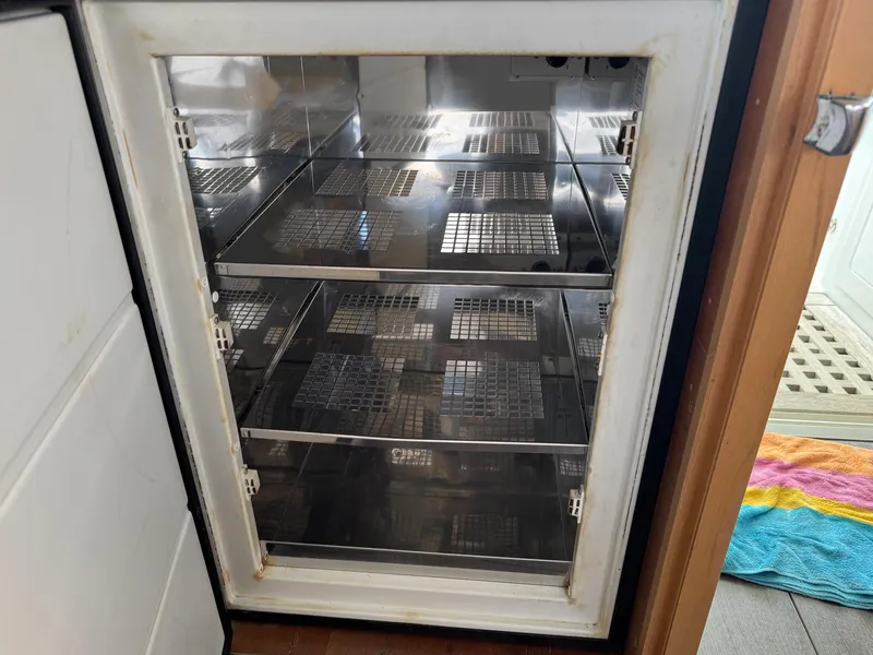 Slide: The Image of Empty refrigerator on a 2017 Lagoon 450 F catamaran, featuring wire shelves. - 35