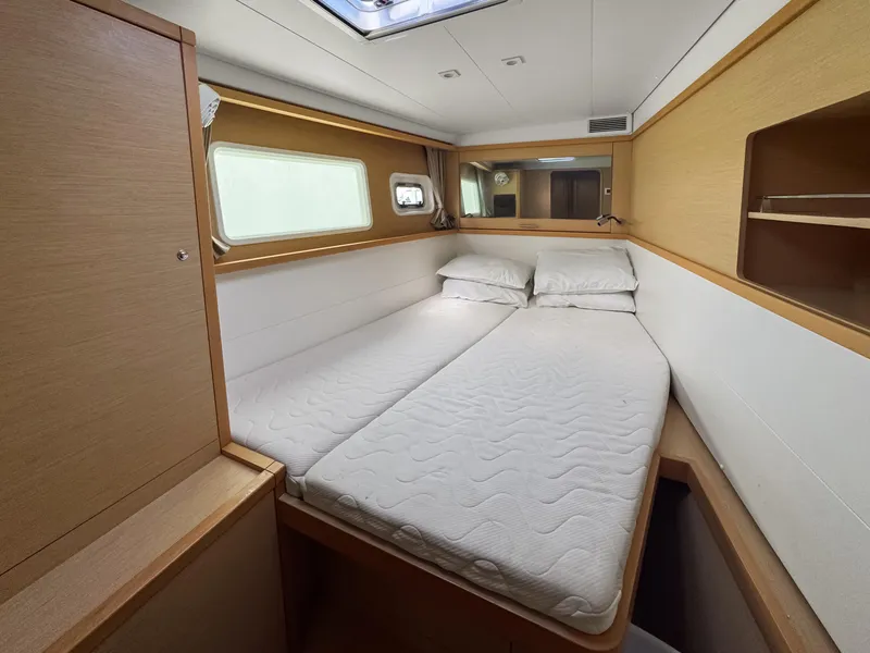 Slide: The Image of 2017 Lagoon 450 F cabin interior with double bed and wooden furnishings. - 44