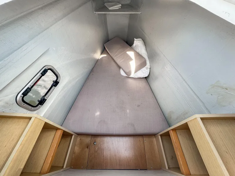 Slide: The Image of 2017 Lagoon 450 F cabin interior with bed and storage shelves. - 47