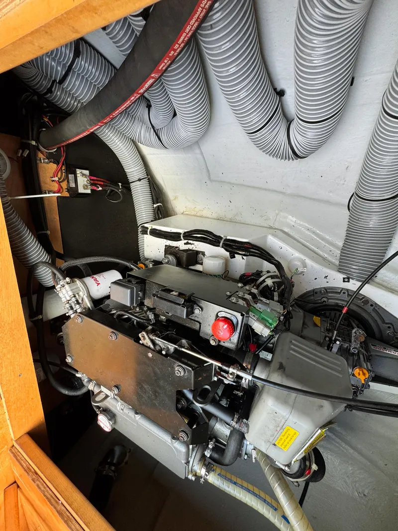 Slide: The Image of Engine compartment of a 2017 Lagoon 450 F catamaran with visible wiring and hoses. - 48