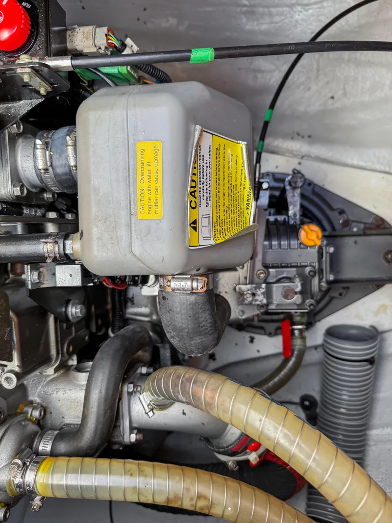 Slide: The Image of Engine compartment of a 2017 Lagoon 450 F catamaran, showing mechanical components and hoses. - 49