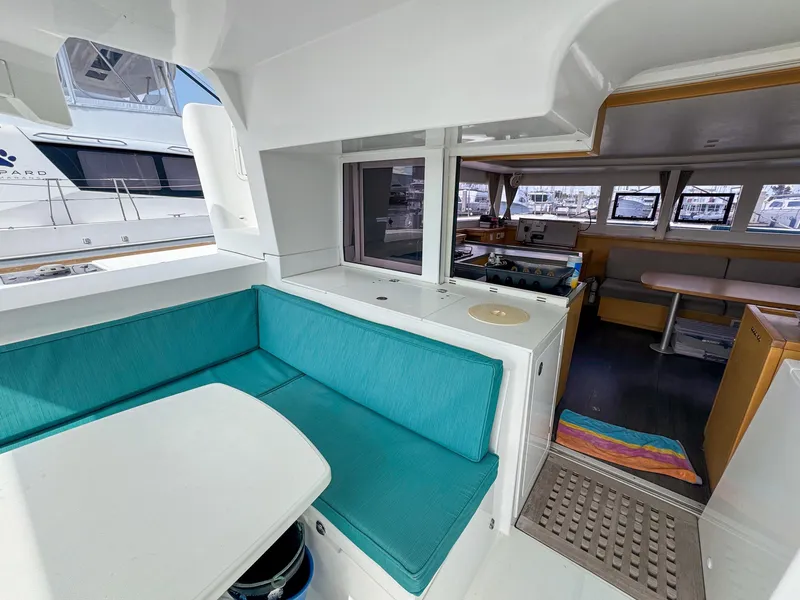Slide: The Image of Interior of 2017 Lagoon 450 F catamaran with turquoise seating and modern kitchen area. - 8