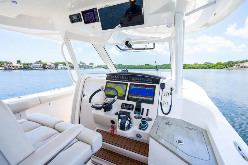 Slide: The Image of 2021 Boston Whaler 350 Realm cockpit with advanced navigation system and luxurious seating. - 10