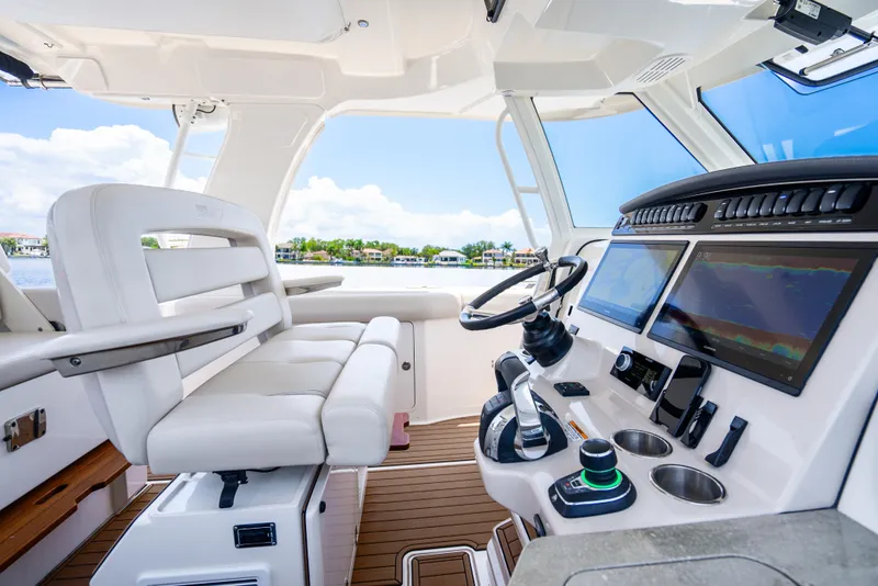 Slide: The Image of 2021 Boston Whaler 350 Realm cockpit with modern controls and seating, showcasing luxury and technology. - 11