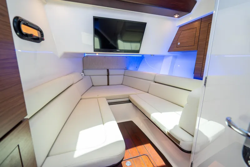 Slide: The Image of Luxurious interior of 2021 Boston Whaler 350 Realm with plush seating and TV. - 13