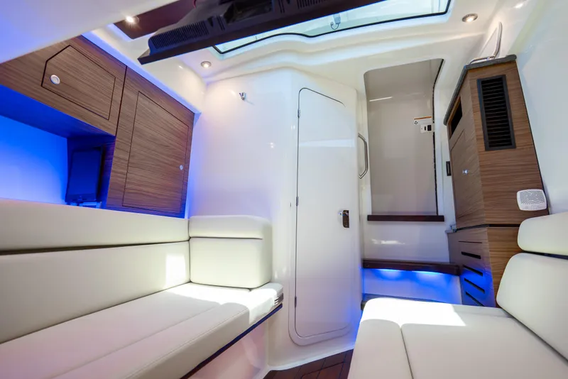 Slide: The Image of Interior of 2021 Boston Whaler 350 Realm, featuring modern seating and ambient lighting. - 15