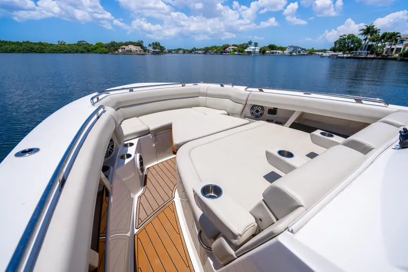 Slide: The Image of 2021 Boston Whaler 350 Realm boat with luxurious seating on a serene lake. - 19