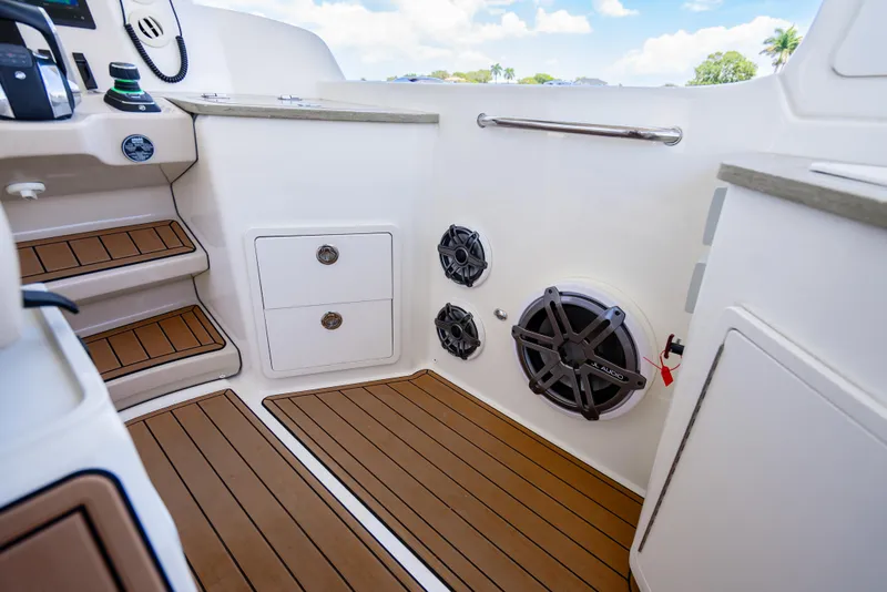 Slide: The Image of Interior of 2021 Boston Whaler 350 Realm, featuring wood flooring and built-in speakers. - 23