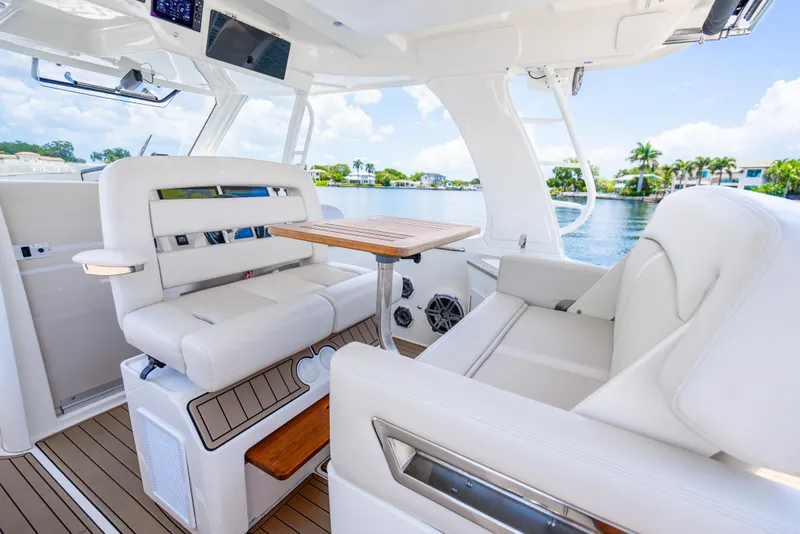 Slide: The Image of Luxurious interior of 2021 Boston Whaler 350 Realm boat with plush seating and wooden table. - 28